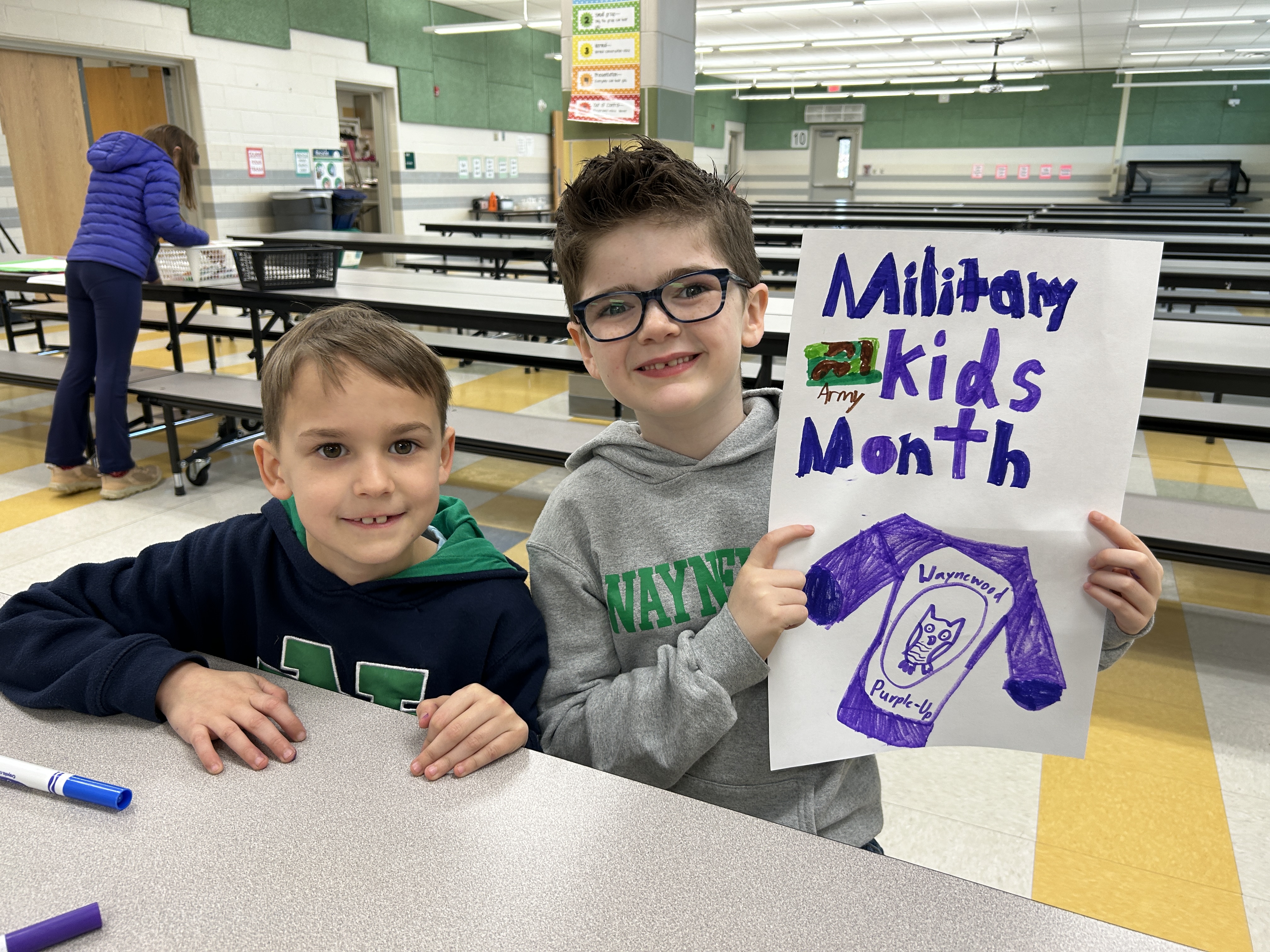 Students making poster for Purple Up week.